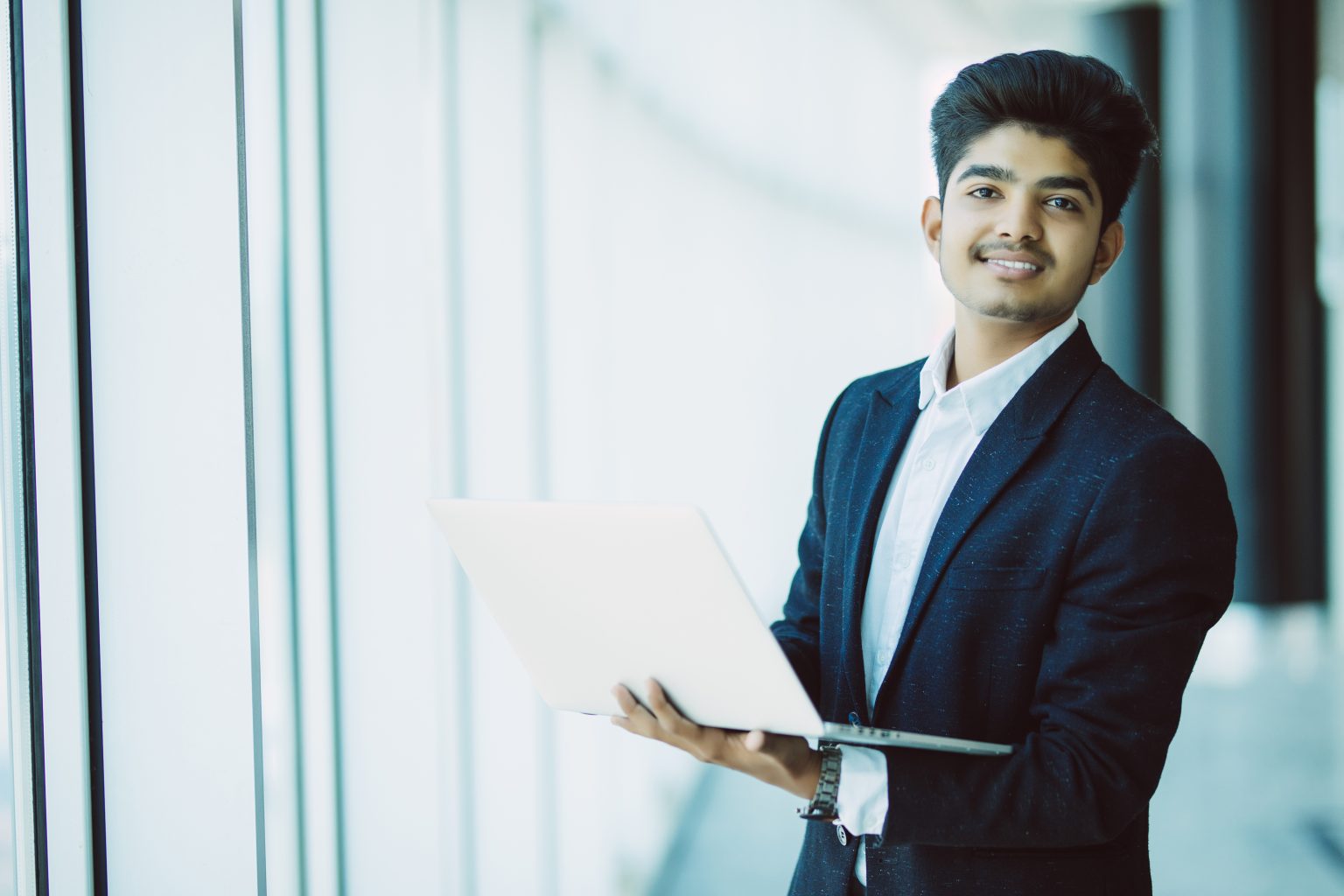Young businessman with laptop computer working at office